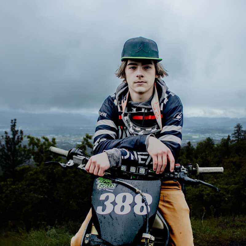 A motorcycle racer posing the day before a big event.