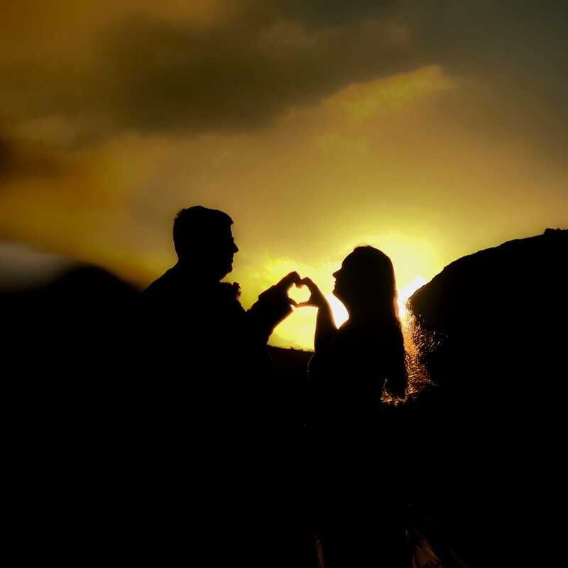 Two lovebirds sharing a moment to pose and commemorate their recent wedding with a sunset photoshoot.
